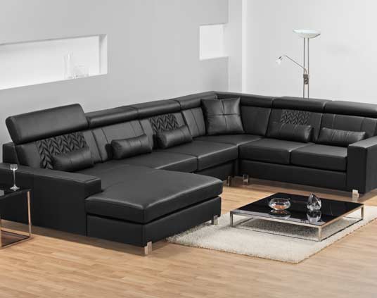 Black leather surround sofas with vine stitch pattern inlays.