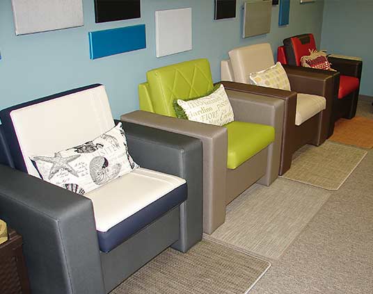 Four padded arm chairs of the same model, but with different upholstery designs
