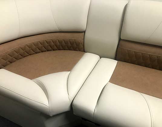 Tan boat sofa with brown Jag pattern inlays.